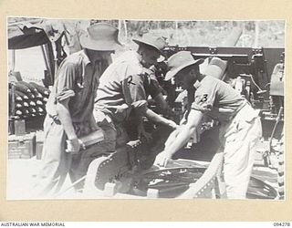 BOIKEN, NEW GUINEA, 1945-07-18. A GUN CREW OF 2/2 FIELD REGIMENT, ROYAL AUSTRALIAN ARTILLERY, LOADING A 25-POUNDER. THESE GUNS FIRE ON JAPANESE POSITIONS IN THE PRINCE ALEXANDER RANGES