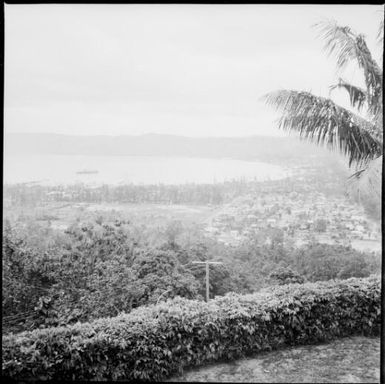 Two ships moored in harbour with a township and a power pole in foreground, Rabaul Harbour, New Guinea, 1937 / Sarah Chinnery