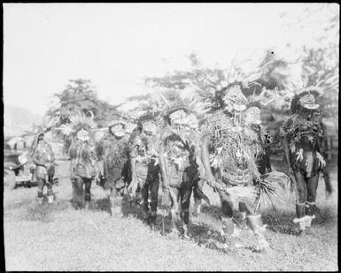 Double row of decorated dancers with person on right legs together, New Guinea, ca. 1929 / Sarah Chinnery