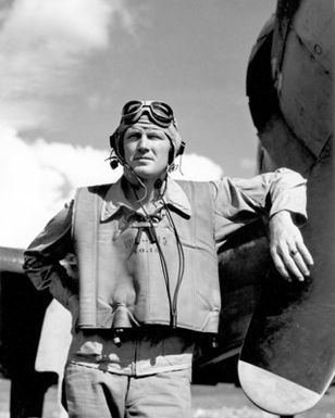 World War II (WWII) era photograph of US Marine Corps (USMC) First Lieutenant (1LT) Sheldon O. Hall, standing next to a US Navy (USN) F4U"CORSAIR"aircraft at Henderson Field, Guadalcanal, 1943. 1LT Hall is an Ace Pilot credited with 6 kills. His hometown is Ottawa, Ohio. (Exact date shot unknown)