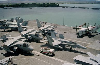 View from pri-fly (Primary Flight Control), down the mid section of the flight deck of the nuclear-powered aircraft carrier USS ABRAHAM LINCOLN (CVN 72). Aircraft visible include F-14B Tomcat aircraft, S-3A Viking, F/A-18 Hornet and a C-2A Greyhound. The LINCOLN is here to take part in Operation RIMPAC 2000