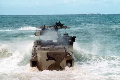 Three AAVP-7 Assault Amphibian Vehicles (AAVs) enter the surf as they return to their ship at the conclusion of Exercise RimPac '88. The AAVs are originally from Marine Corps Base, 29 Palms, Calif