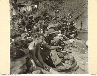 ZENAG, NEW GUINEA, 1944-02-27. SPECTATORS AT A SPORTS CARNIVAL HELD IN A CREEK DAMMED BY MEMBERS OF THE 2/9TH FIELD COMPANY, ROYAL AUSTRALIAN ENGINEERS. THE CARNIVAL, ATTENDED BY VISITORS FROM ..