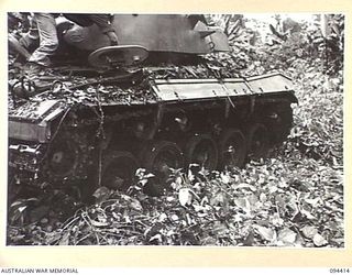 TOROKINA AREA, BOUGAINVILLE. 1945-07-28. AN M24 GENERAL CHAFFEE LIGHT TANK DURING TESTS CONDUCTED FOR THE WAR OFFICE. ITS TRACKS ARE CLOGGED AT THE REAR BUT NOT AT THE FRONT