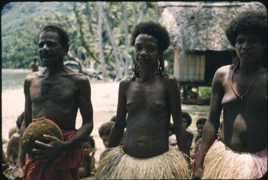 Lower Normanby, decorated houses, and close up view of three people : Normanby Island, D'Entrecasteaux Islands, Papua New Guinea, 1956-1959 / Terence and Margaret Spencer