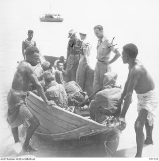 WASU, PAPUA, NEW GUINEA. 1944-03-25. JAPANESE PRISONERS OF WAR LEAVING WASU FOR THE AS27 WATER TRANSPORT BOAT IN THE BACKGROUND. IDENTIFIED PERSONNEL ARE: WX8342 LIEUTENANT H. E. READ, PAPUAN ..