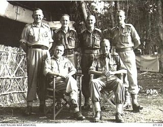 KILIGIA, NEW GUINEA, 1944-03-16. THE GENERAL OFFICER COMMANDING HEADQUARTERS, 5TH DIVISION, VX27 MAJOR-GENERAL A.H. RAMSAY, CBE, DSO, ED, (1) WITH HIS SENIOR STAFF. IDENTIFIED PERSONNEL ARE: ..