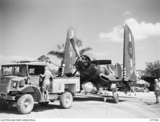 PERSONNEL OF NO. 3 SERVICING UNIT, HEADQUARTERS, ROYAL NEW ZEALAND AIR FORCE USING A TRUCK TO TOW A NEWLY OVERHAULED CHANCE-VOUGHT, "CORSAIR" AIRCRAFT OF NO. 16 SQUADRON, ROYAL NEW ZEALAND AIR ..