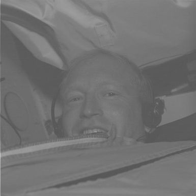 STS-48 MS Gemar peers over a stowage bag on OV-103's middeck