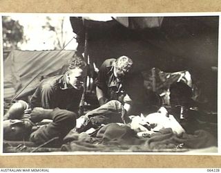 CANNING'S SADDLE, NEW GUINEA. 1944-01-22. WOUNDED OF THE 2/12TH INFANTRY BATTALION RECEIVING TREATMENT AT CHEN'S POST ON CANNINGS SADDLE AFTER THE SUCCESSFUL ATTACK ON THE ENEMY POSITIONS IN THE ..