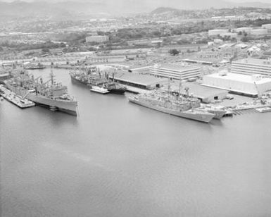 An aerial view of the guided missile frigates USS GARY (FFG 51), USS RENTZ (FFG 46) and the fast combat support ship USS CAMDEN (AOE 2) moored to piers