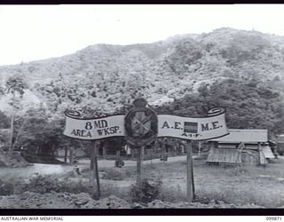 RABAUL, NEW BRITAIN. 1 MARCH 1946. THE UNIT SIGN AT THE ENTRANCE TO THE CAMP AREA OF 8 MILITARY DISTRICT AREA WORKSHOP, CORPS OF AUSTRALIAN ELECTRICAL AND MECHANICAL ENGINEERS, SHOWING THE UNIT'S ..