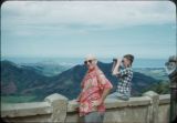 Page Stegner and unidentified man at a Nu'uanu Pali State Park lookout with the Koʻolau Mountain Range in the background