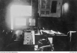 PORT MORESBY, PAPUA, 1942-1943. THE INTERIOR OF THE AUSTRALIAN ARMY AMENITIES SERVICE'S MOBILE CINEMA NO. 76, WITH THE PROJECTION DOOR OPEN AT REAR. THE CINEMA IS USING A C. AND W. P5 PROJECTOR ..