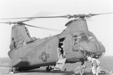 A CH-46 Sea Knight helicopter prepares to take off from the flight deck of the amphibious assault ship USS GUAM (LPH 9) during field training Exercise SOLID SHIELD'87