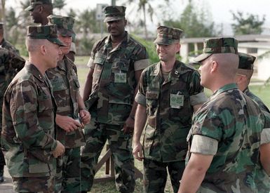 Major General Wayne E. Rollings, Commanding General, Third Marine Expeditonary Force, talks with officers and staff of Bravo Company, 1ST Battalion, 6th Marines, during his visit to the housing area in Tiyan, Guam, during Operation PACIFIC HAVEN. PACIFIC HAVEN provided Kurdish evacuees political asylum from Iraq. While on Guam, the Kurds are provided shelter, food, clothing, medical care and assimilation classes for life in the United States