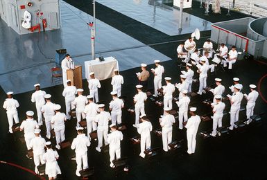 Chaplain Jerry McNabb officiates at a sunrise Easter service on the deck of the amphibious command ship USS BLUE RIDGE (LCC-19)