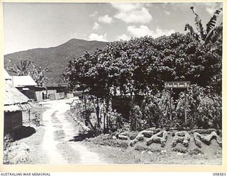 WAU, NEW GUINEA. 1945-10-17. THE ENTRANCE TO 5 INDEPENDENT FARM PLATOON. IT IS SITUATED IN THE WAU VALLEY NEAR THE SITE OF THE PRE- WAR WAU FARM