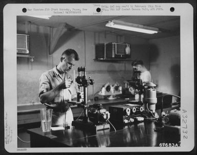 A "GI" of the 27th Air Depot Group uses a drill press to polish a flight indicator rotor at the instrument shop. Port Moresby Air Depot, Papua, New Guinea. (U.S. Air Force Number 67683AC)