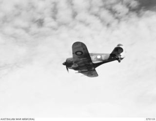 RAMU VALLEY, NEW GUINEA. 1944-01-02. A BOOMERANG AIRCRAFT OF "A" FLIGHT, NO. 4 (TACTICAL RECONNAISSANCE) SQUADRON, DROPPING A MESSAGE TO GROUND TROOPS