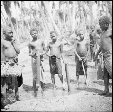 Boys filling bamboo water carriers, Rabaul, New Guinea, 1937 / Sarah Chinnery