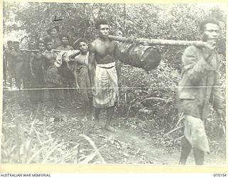 HANSA BAY-SEPIK RIVER AREA, NEW GUINEA. 1944-08-02. SEPIK RIVER NATIVES EMPLOYED AS CARRIERS BY THE 30TH INFANTRY BATTALION, TAKING FOOD SUPPLIES UP TO THE FORWARD OUTPOSTS OF THE UNIT