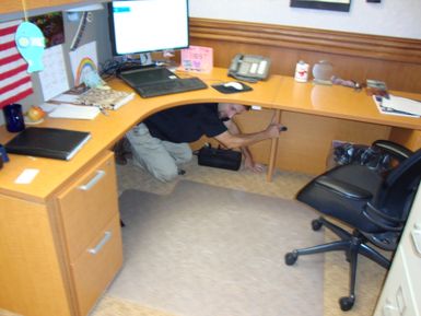 Fort Shafter, Hawaii, Oct. 18, 2012 -- FEMA Region IX employees in the Hawaii office practice "drop, cover, and hold on" during ShakeOut