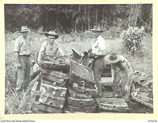 LAE-NADZAB, NEW GUINEA. 1944-07-25. PERSONNEL OF THE 8TH LINES OF COMMUNICATION SALVAGE DEPOT SORTING OUT CAR AND TRUCK RADIATORS IN PREPARATION FOR DESPATCH BACK TO THE MAINLAND. IDENTIFIED ..