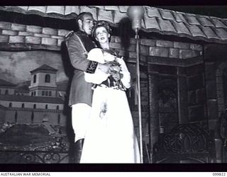 RABAUL, NEW BRITAIN, 1946-02-05. CORPORAL I.R BODINNER (ANGELA) AND SERGEANT C.L. CROFT (THE GOVERNOR) SINGING THEIR DUET DURING THE PERFORMANCE OF THE MUSICAL COMEDY "THE MAID OF THE MOUNTAINS" BY ..