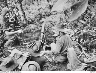 KOMIATUM RIDGE, NEW GUINEA. 1943-07. 2/3RD AUSTRALIAN INDEPENDENT COMPANY MOUNT A VICKERS MEDIUM MACHINE-GUN IN A GUN-PIT TYPICAL OF OTHERS IN THE AREA, COMMANDING ENEMY MOVEMENT ALONG THE RIDGE. ..