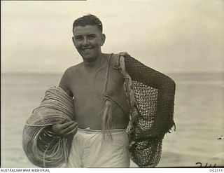 TOROKINA, BOUGAINVILLE ISLAND, SOLOMON ISLANDS. C. 1945-03-01. SUNTANNED-LOOKING LEADING AIRCRAFTMAN C. N. TAYLOR OF NARRTAWARRA, SA, SEEMS TO ENJOY HIS OPEN-AIR LIFE AS A MEMBER OF THE RAAF'S ..