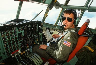 CAPT. Wayne Shatz, pilot with the 374th Tactical Airlift Wing, flies a Christmas Drop mission in a C-130 Hercules aircraft. The annual airdrop is a humanitarian effort providing aid to needy islanders throughout Micronesia during the holiday season