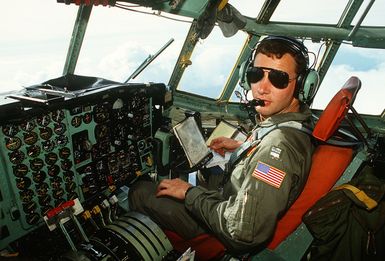 CAPT. Wayne Shatz, pilot with the 374th Tactical Airlift Wing, flies a Christmas Drop mission in a C-130 Hercules aircraft. The annual airdrop is a humanitarian effort providing aid to needy islanders throughout Micronesia during the holiday season