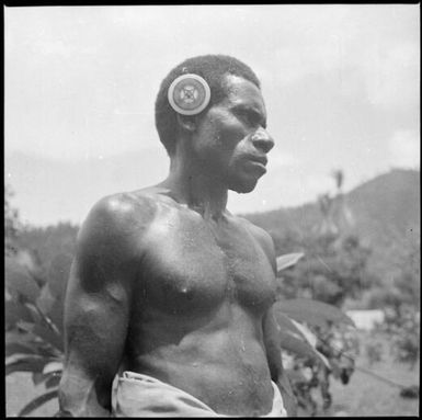Man wearing a kapkap, silhouetted against the skyline, Rabaul, New Guinea, ca. 1936 / Sarah Chinnery