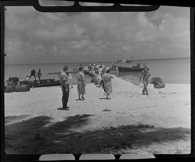 Crew and passengers are escorted to the TEAL (Tasman Empire Airways Limited) Flying Boat, Akaiami, Aitutaki, Cook Islands