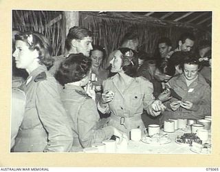 LAE, NEW GUINEA. 1944-08-09. GUESTD AND HOSTS ENJOYING THEMSELVES DURING SUPPER AT A DANCE ORGANISED BY MEMBERS OF THE LAE BASE SUB AREA FOR THE STAFF OF THE 2/7TH AUSTRALIAN GENERAL HOSPITAL, THE ..