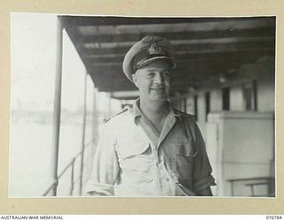 MADANG, NEW GUINEA. 1944-10-31. COMMANDER E.A. GOOD, RAN ABOARD THE HMAS PING WO, AN OLD CHINESE RIVER STEAMER NOW USED AS AN OFFICE BY THE RAN ADMINISTRATION STAFF