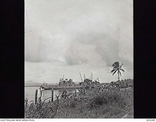 MILNE BAY, NEW GUINEA. 1943-03. THE FORMER HAWKESBURY RIVER FERRY GEORGE PEAT (LEFT), REQUISITIONED FOR SERVICE WITH THE AUSTRALIAN ARMY, ALONGSIDE LYLES PIER. (NAVAL HISTORICAL COLLECTION)