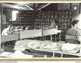 PORT MORESBY, NEW GUINEA. 1943-12-06. STAFF AT WORK IN THE CONTROL OFFICE OF NO. 2 SUB DEPOT, 10TH AUSTRALIAN ADVANCED ORDNANCE DEPOT. IDENTIFIED PERSONNEL ARE: NX116858 SERGEANT A. JONES (1); ..