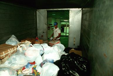 CPT Michael Crupe pauses while packing a truck with donated items for Christmas Drop, a humanitarian airdrop effort providing aid to needy islanders throughout Micronesia during the holiday season. Crupe, a member of the 605th Military Airlift Support Squadron, is chairman of the program