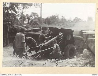 SORAKEN, BOUGAINVILLE. 1945-06-05. NO. 1 GUN, C TROOP, 11 BATTERY, 4 FIELD REGIMENT ENGAGING A TARGET ON COMMO RIDGE. IDENTIFIED PERSONNEL ARE:- SERGEANT T.G. BROOKES (1); GUNNER A.H. BIRD (2); ..