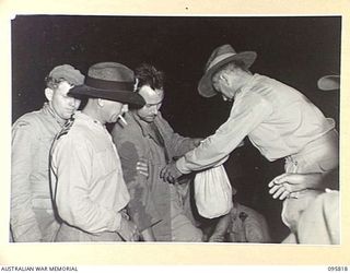 JACQUINOT BAY, NEW BRITAIN. 1945-09-07. AFTER THE JAPANESE SURRENDER, ALLIED PRISONERS, MOST OF THEM IN EMACINATED CONDITION, WERE PICKED UP AT RABAUL BY HMAS VENDETTA AND BROUGHT TO JACQUINOT BAY. ..