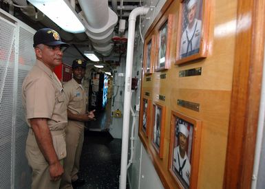 U.S. Navy MASTER CHIEF PETTY Officer of the Navy (MCPON) Joe R. Campa Jr., views a photo roster board of Sailors on Oct. 30, 2006, assigned to the Ticonderoga-class guided missile cruiser USS LAKE ERIE (CG 70) during a visit to Naval Station Pearl Harbor. (U.S. Navy PHOTO by Mass Communication SPECIALIST 1ST Class James E. Foehl) (Released)