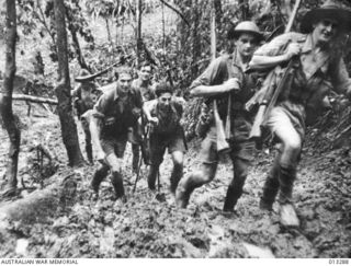 Some members of D Company, 39th Battalion, returning to their base camp after a battle at Isurava. Right to left: Warrant Officer 2 R. Marsh, Private (Pte) G. Palmer, Pte J. Manol, Pte J. Tonkins, ..