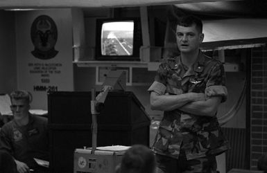 The commanding officer of Marine Medium Helicopter Squadron 261 (HMM-261) delivers a pre-operation briefing to his officers in the squadron ready room aboard the amphibious assault ship USS SAIPAN (LHA 2). The SAIPAN is on station off the coast of Liberia for Operation Sharp Edge