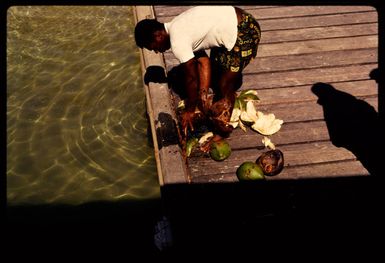 Splitting coconuts, Fiji, 1971