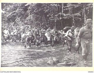 TOROKINA, BOUGAINVILLE. 1945-09-23. JAPANESE NAVAL TROOPS ATTEMPTING TO GET A QUICK DRINK FROM A FORD DURING THEIR 10-MILE MARCH FROM THE BUKA AREA ESCORTED BY TROOPS OF 27 INFANTRY BATTALION. THE ..