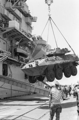 An LAV25 light armored vehicle is loaded aboard the amphibious assault ship USS GUAM (LPH 9) during the field training Exercise SOLID SHIELD'87