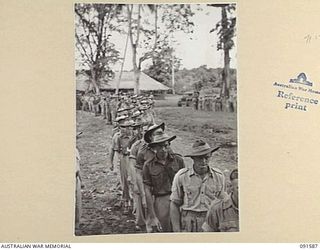 LAE, NEW GUINEA, 1945-05-09. HEADQUARTERS FIRST ARMY TROOPS FILING INTO THE GARRISON CHAPEL FOR THE CHURCH OF ENGLAND AND OTHER PROTESTANT DENOMINATIONS THANKSGIVING SERVICE TO MARK THE END OF ..