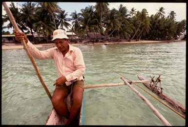 Man in outrigger canoe, Cook Islands